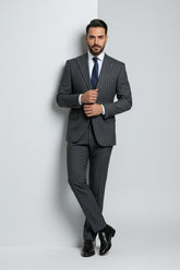 Man in charcoal pinstripe two-piece suit with tailored fit and navy tie.